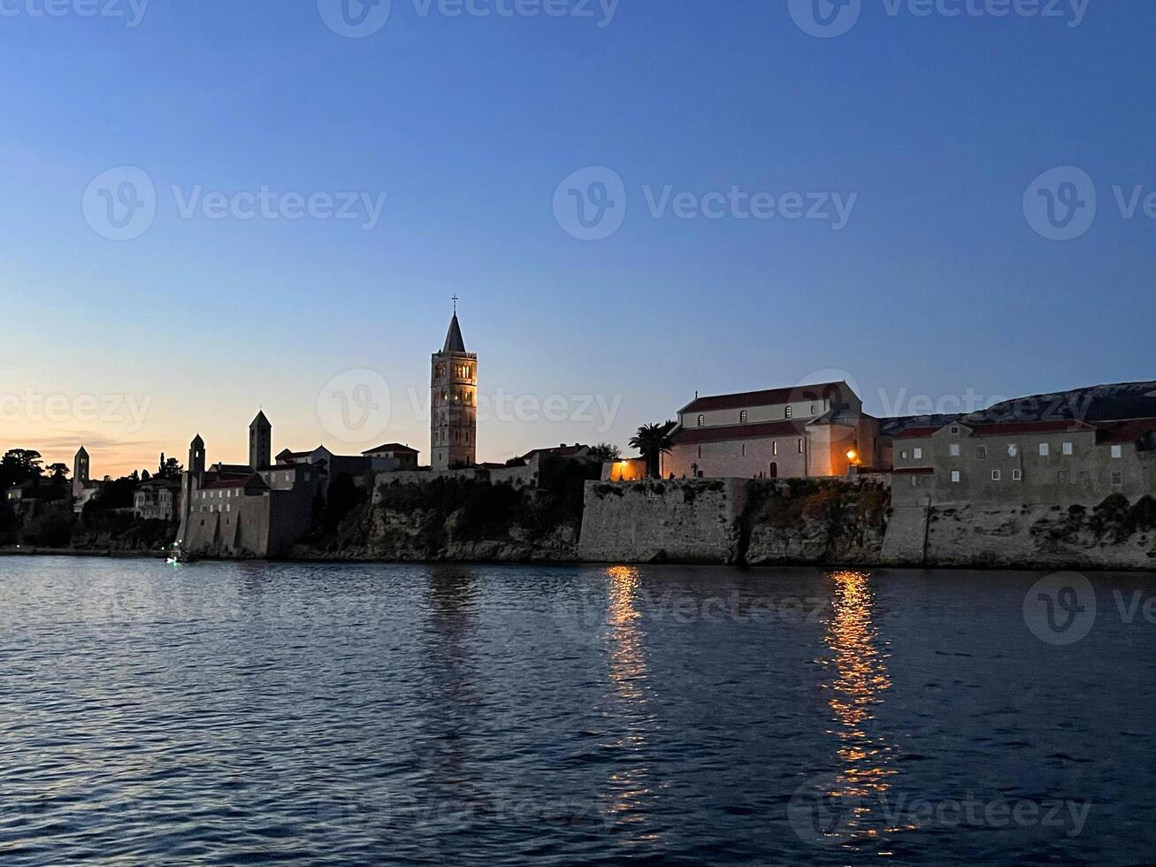 a view of the city of rab at dusk photo