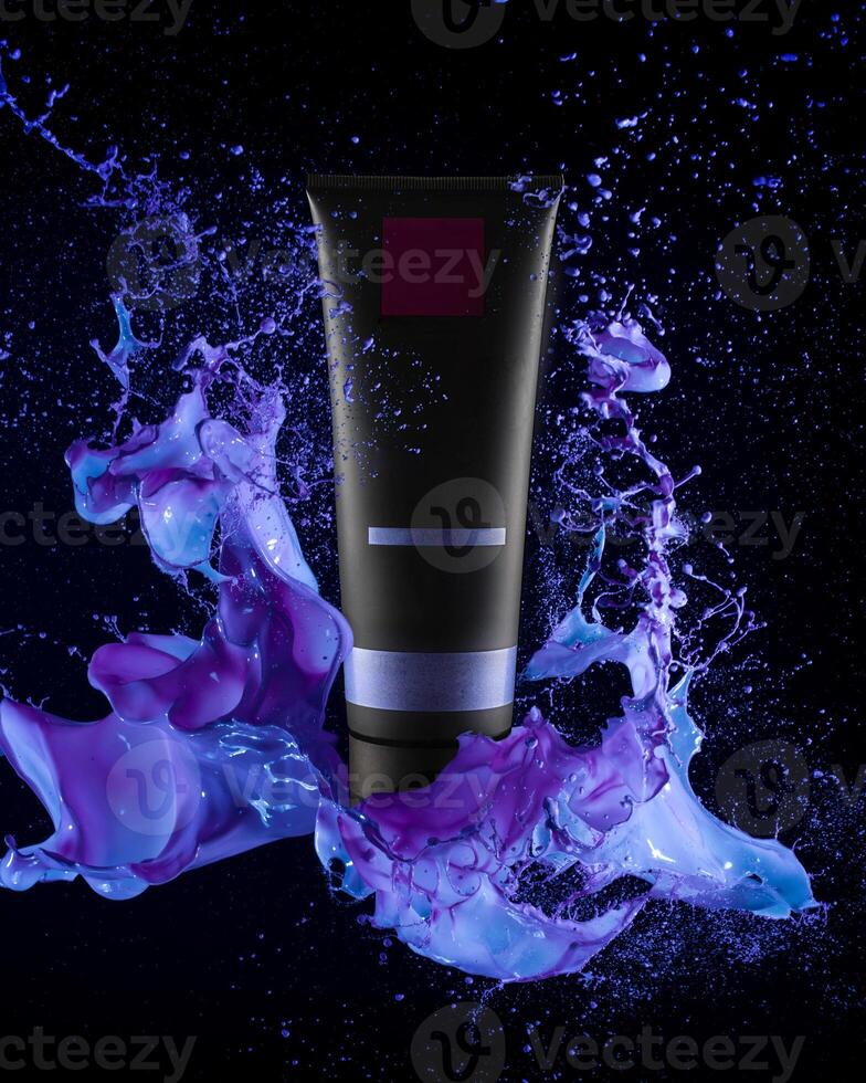 a tube of cream is splashed with purple liquid photo