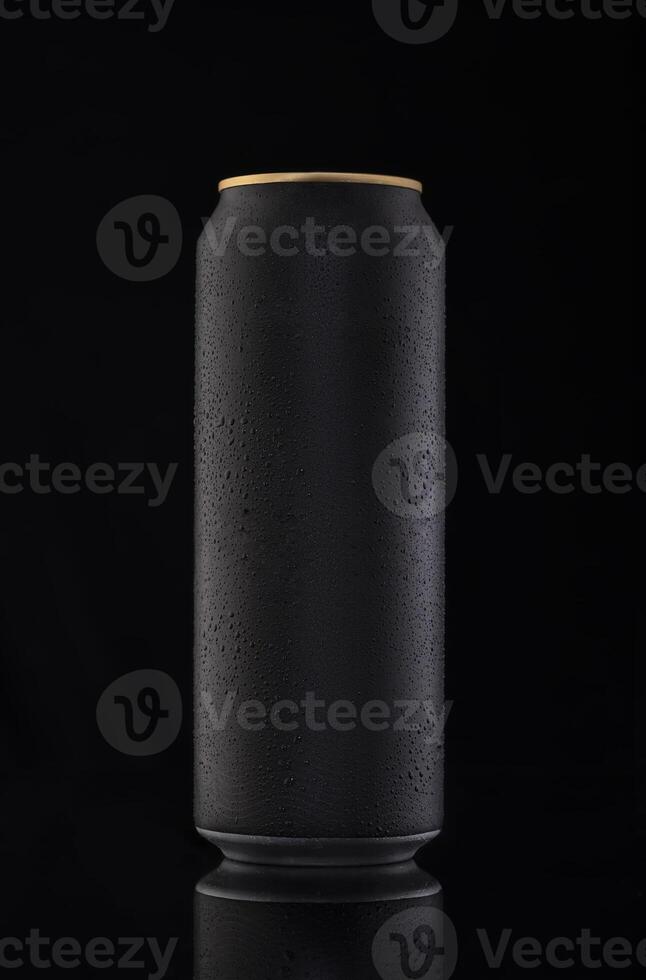 a black can of beer on a black background photo