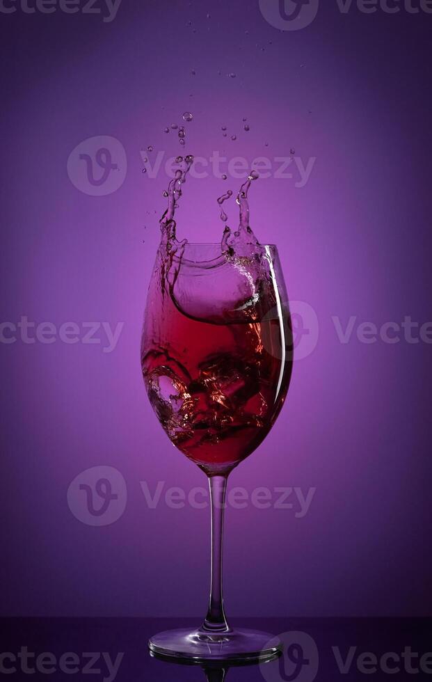 a glass of wine with a splash of liquid photo
