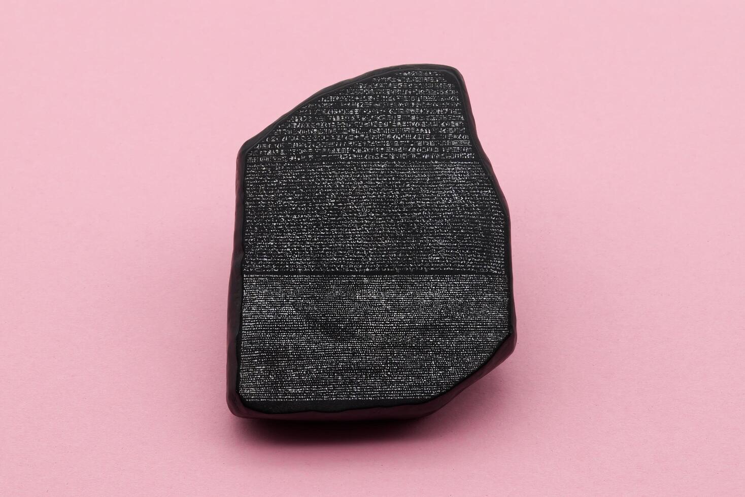 The Rosetta Stone model isolated on pink background. photo