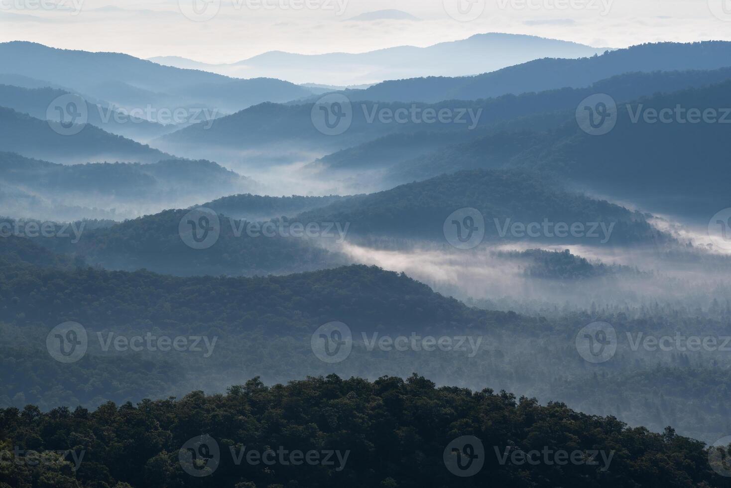 Smoky blue Appalachian mountains shrouded in fog and mist photo