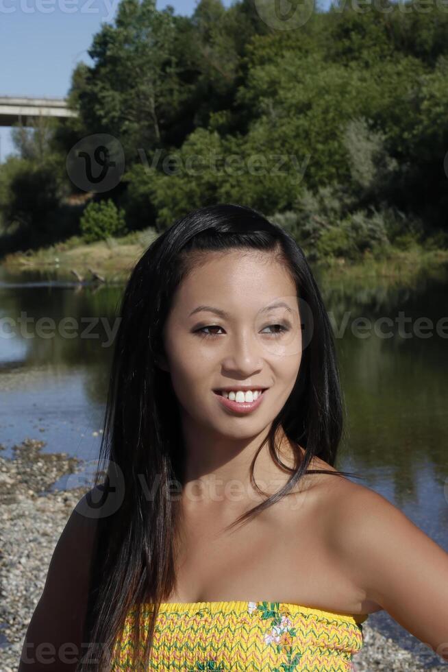 Outdoor Portrait Smiling Asian American Woman At River photo