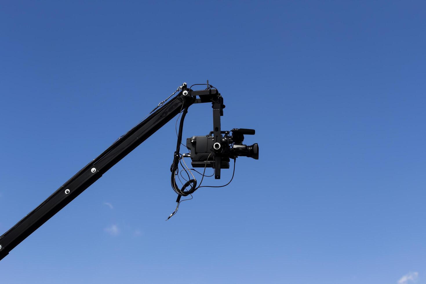 Cusco, Peru, 2015 - Professional Video Camera Attached To Jib Against Blue Sky photo
