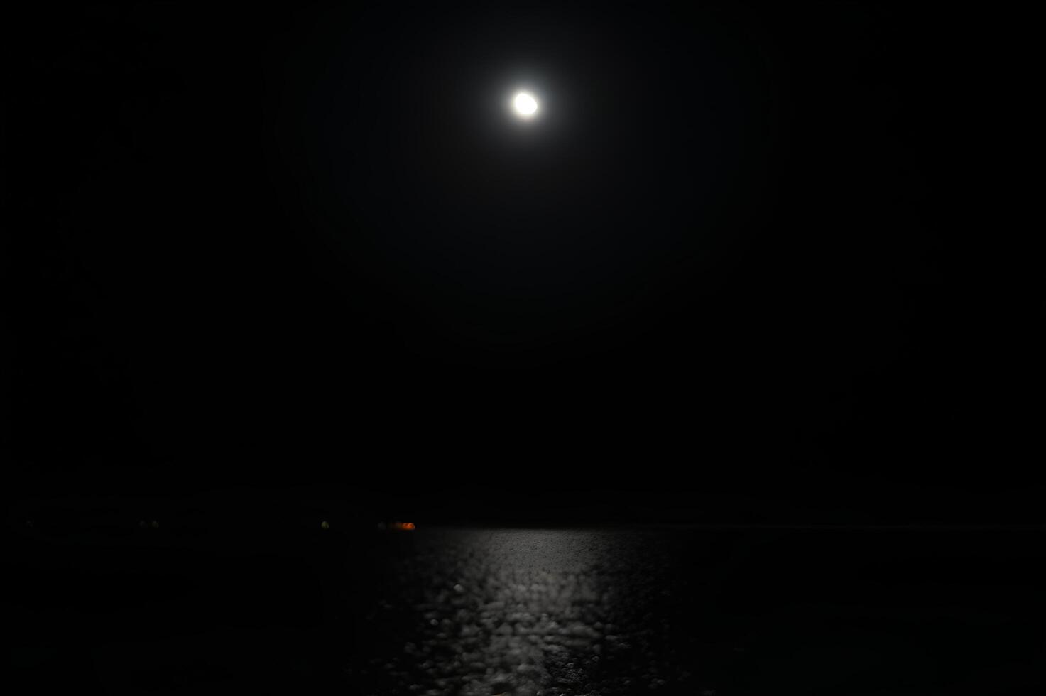 A dark night sky with a full moon photo
