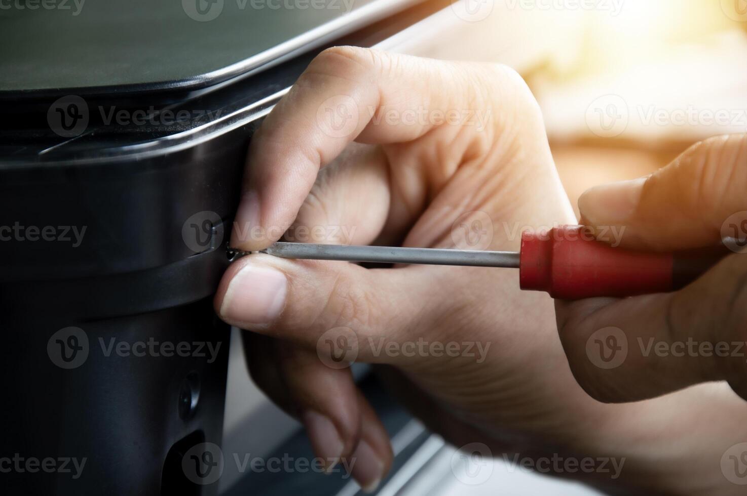Screwdriver tightens the screws. repair tools Mechanic or engineer tools photo