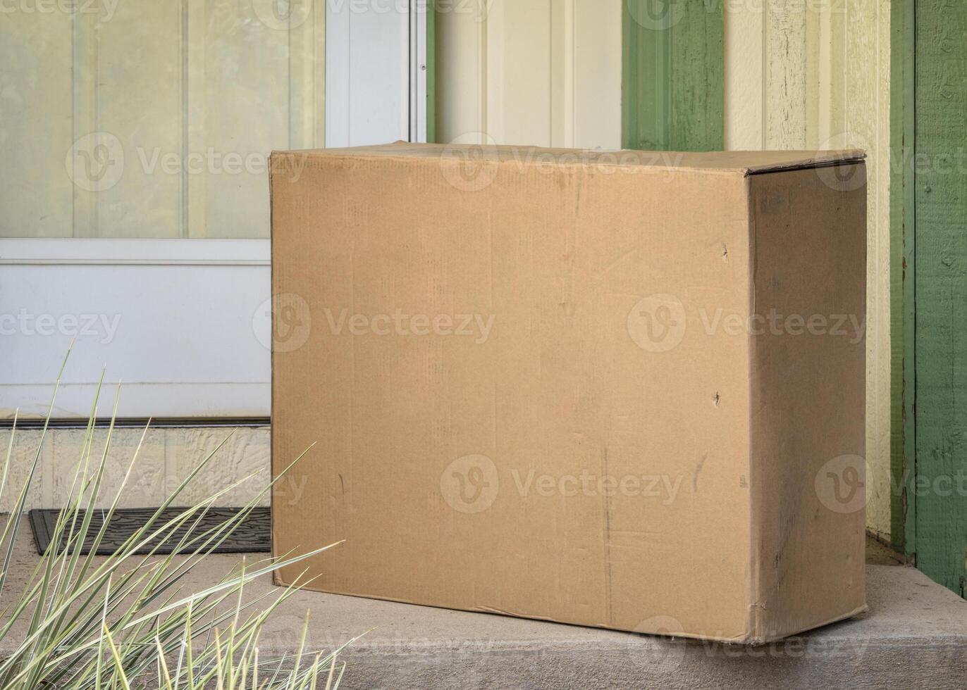 big package at a house doors - mail order and home delivery concept photo