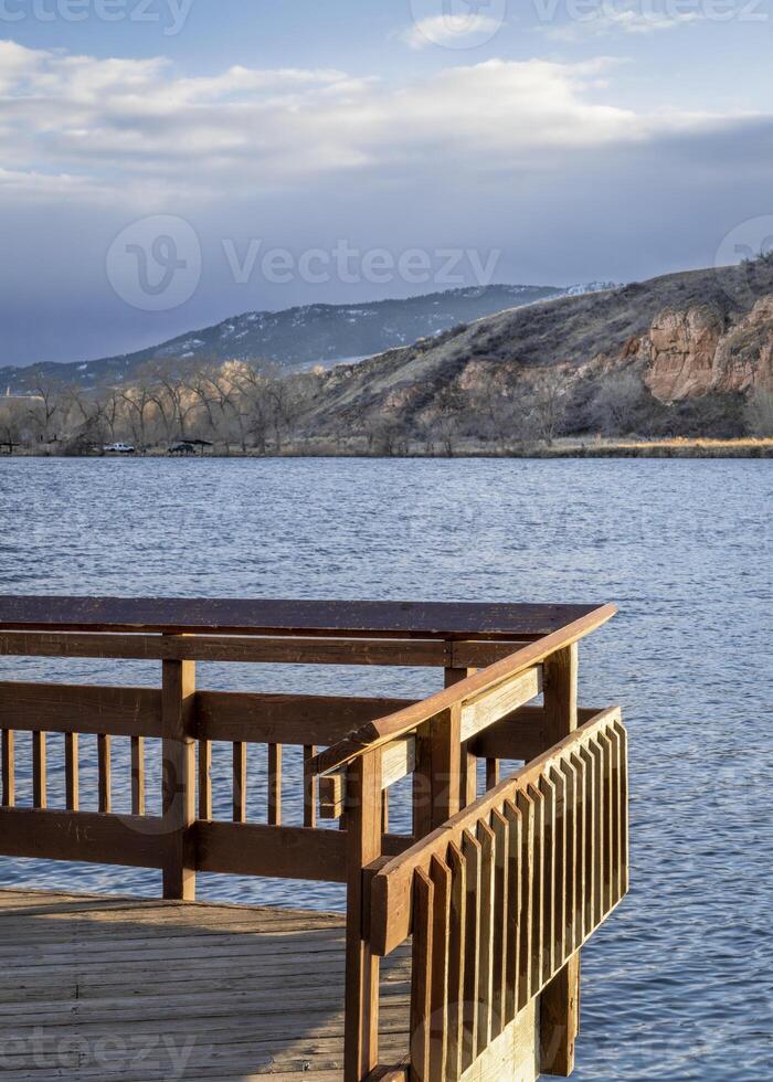 Fishing pier on a lake at Colorado foothills - Watson Lake State Wilderness Area in winter windy conditions photo