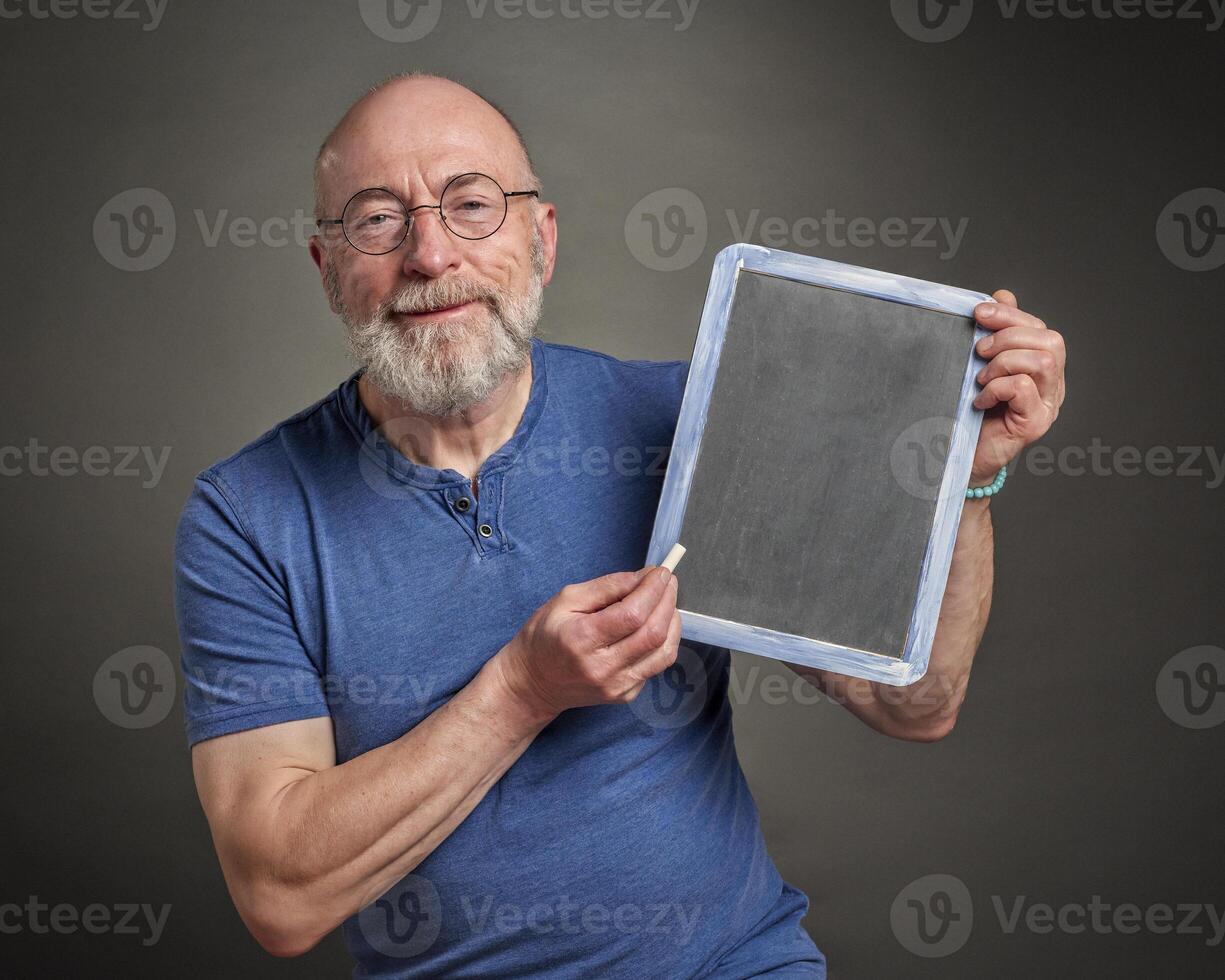 senior man with blank blackboard board photo