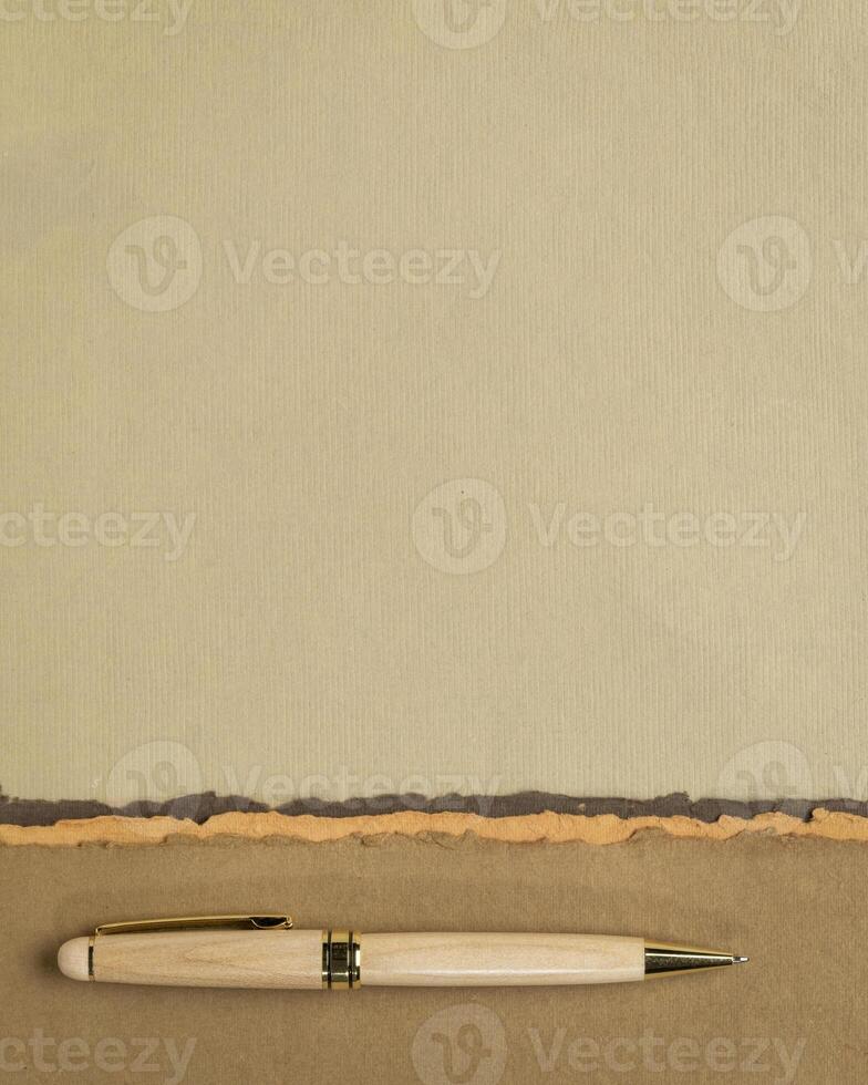 abstract paper landscape in pastel earth tones tones - collection of handmade rag papers with a pen photo