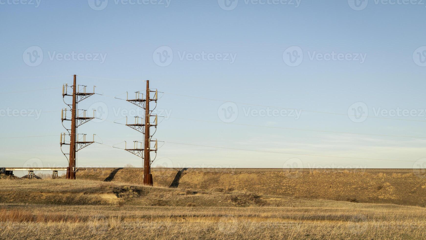 industrial landscape of northern Colorado with a power line and railroad, early spring photo