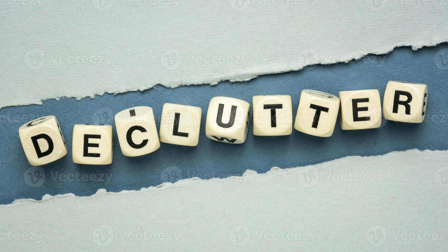 declutter word in wooden dice cubes on a handmade textured paper, simplicity, minimalism and lifestyle concept photo