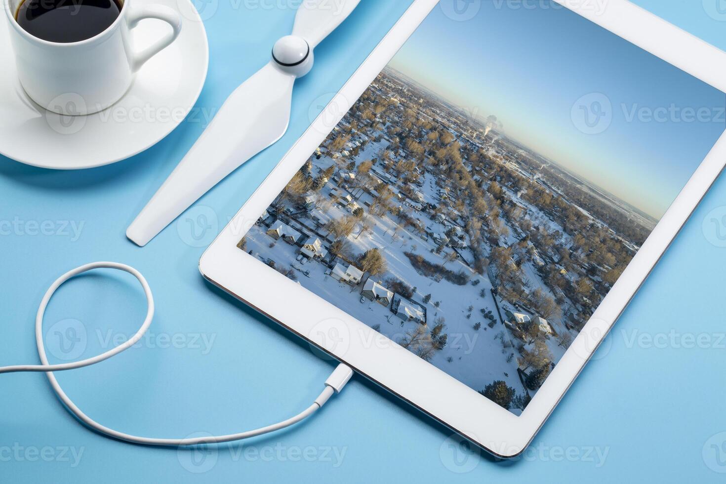 cold winter sunrise over residential area of Fort Collins and Rocky Mountains in northern Colorado, aerial image displayed on a digital tablet photo