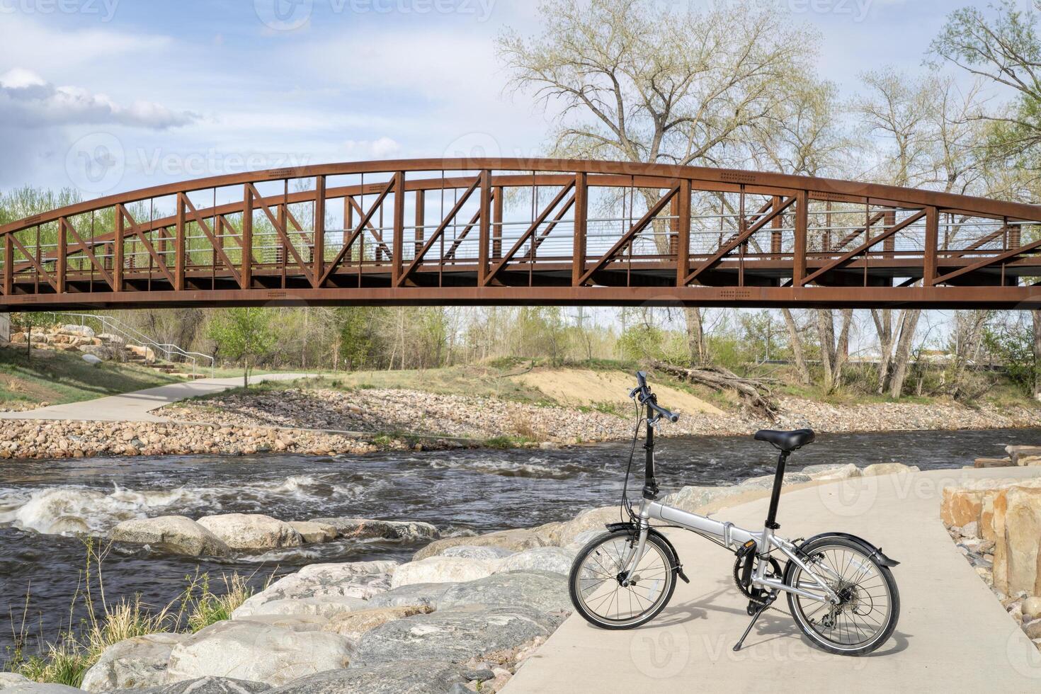 lightweight folding bike at whitewater park on the Poudre River in downtown of Fort Collins, Colorado, spring scenery photo