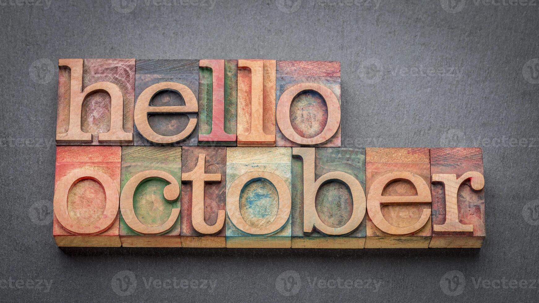 hello October greeting card - letterpress wood type blocks against gray slate stone photo