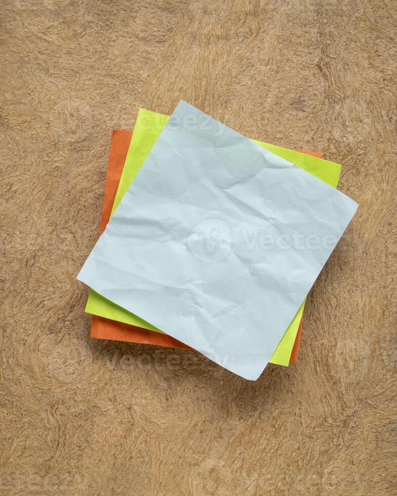 colorful blank reminder note on textured bark paper photo
