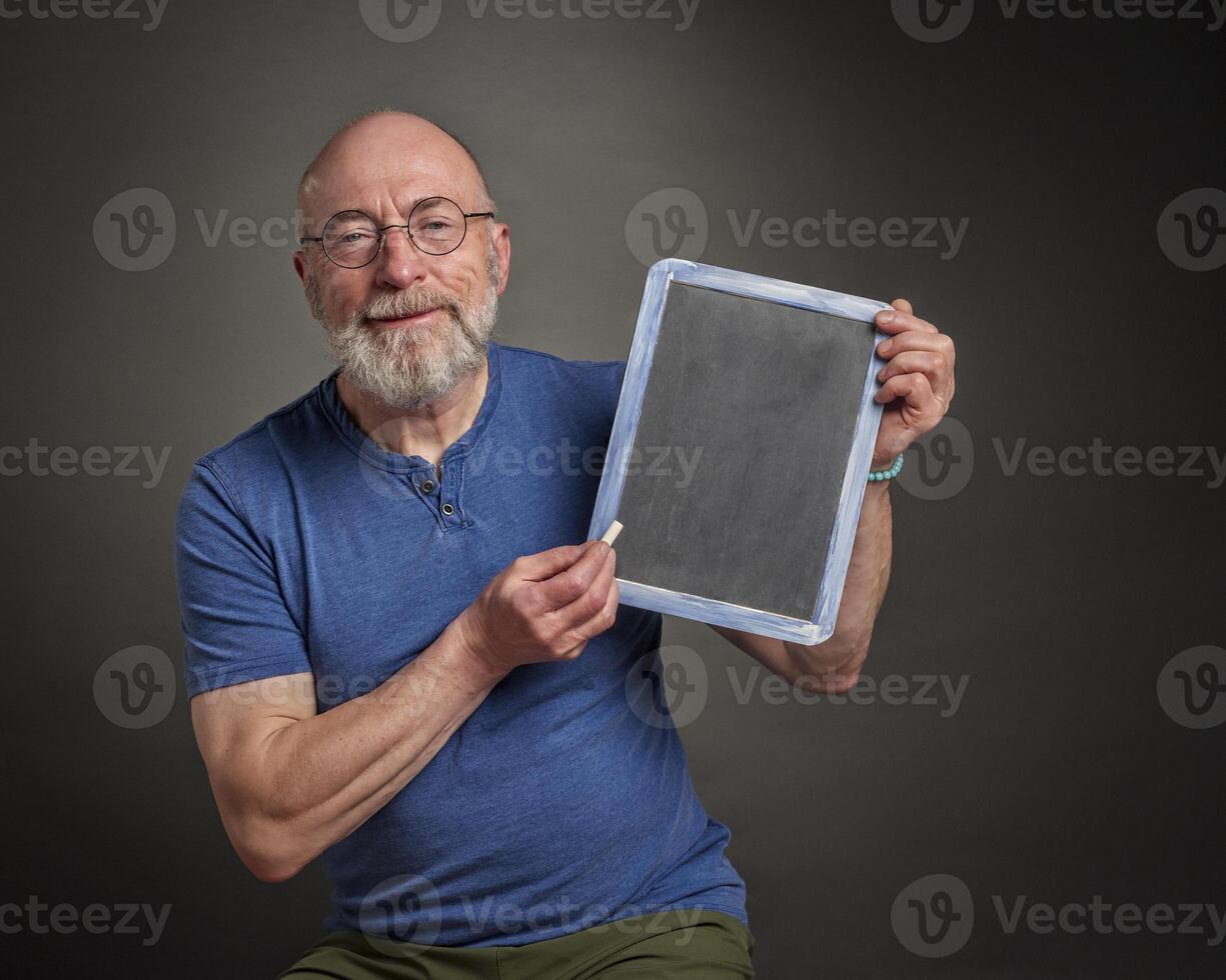 senior man, teacher, mentor or presenter, with blank blackboard, education, presentation and business communication concept photo