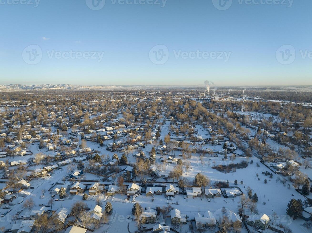 cold winter sunrise over residential area of Fort Collins and Rocky Mountains in northern Colorado with fresh snow, aerial view photo