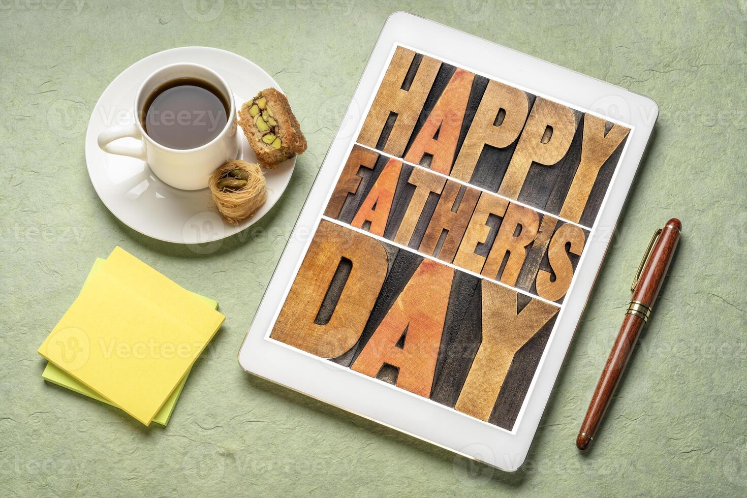 happy father's day - a word abstract in vintage letterpress wood type on a digital tablet with a cup of coffee, greeting card photo