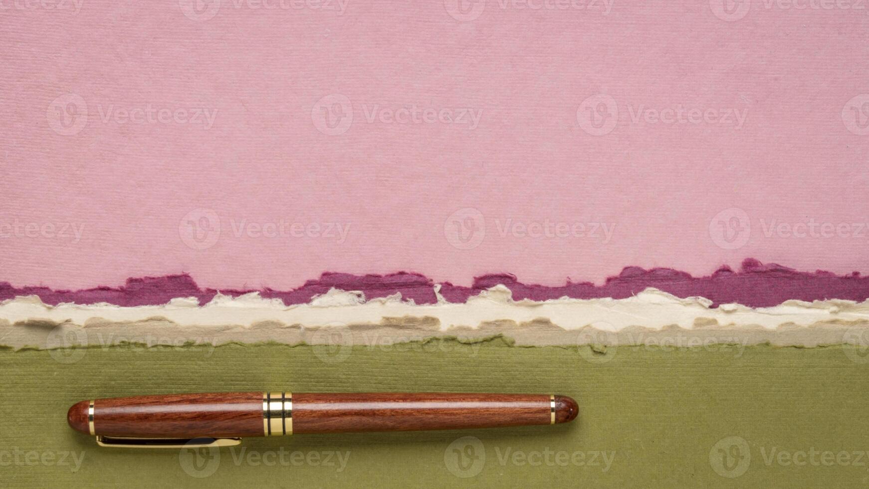 abstract landscape in pink and green pastel tones with a luxury wooden pen - a collection of handmade rag papers photo