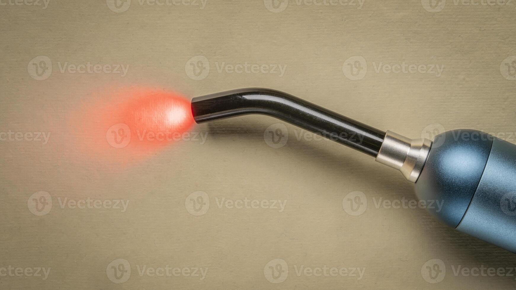 red an infrared light therapy - a small torch light for local treatment and pain relief photo