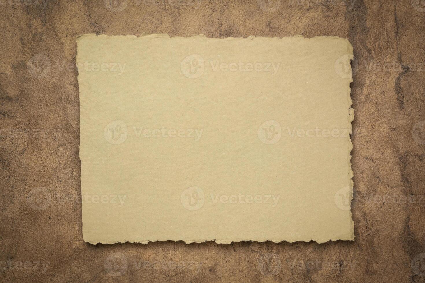 abstract in  earth tone, a sheet of blank Indian handmade rag paper against textured bark paper, copy space photo