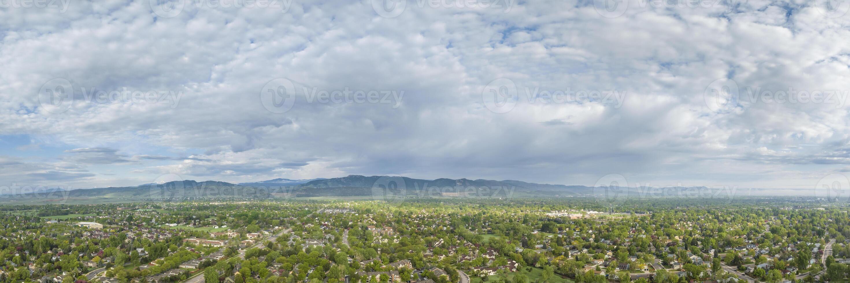 residential area of Fort Collins and Rocky Mountains foothills in northern Colorado, aerial panorama view in springtime scenery photo