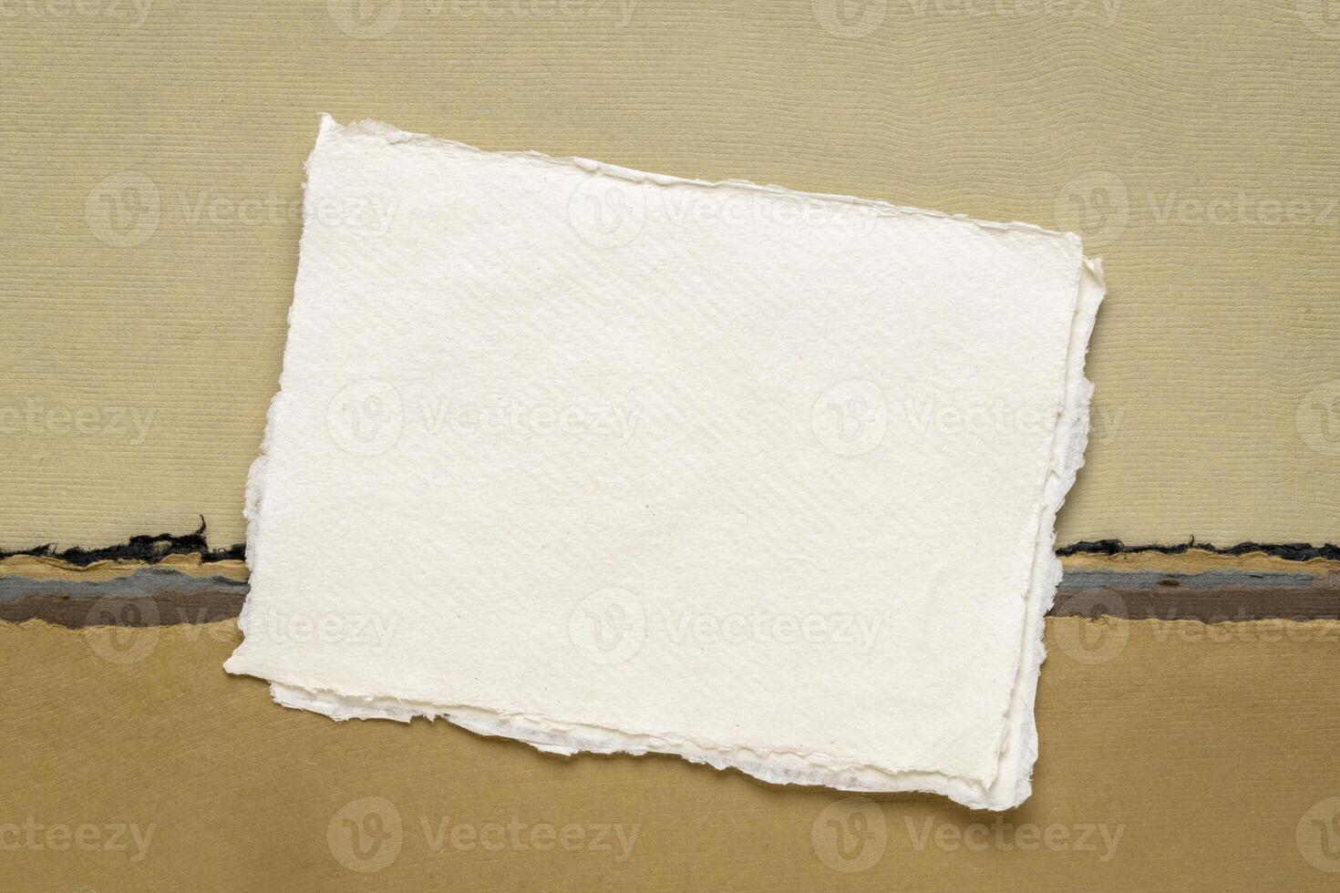 small sheet of blank white Khadi rag paper from India against abstract landscape in earth tones photo