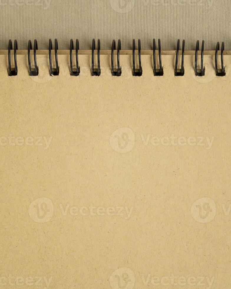 blank spiral notebook on art paper in earth tones photo