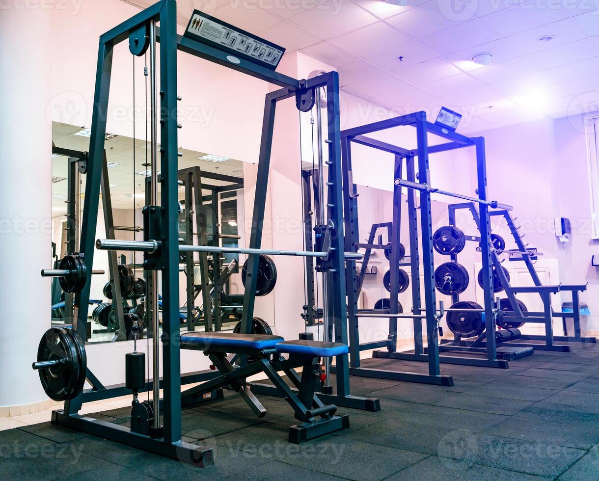 Modern equipment for doing sport exercises in the light gym. Fitness and gym workout items in sports club photo