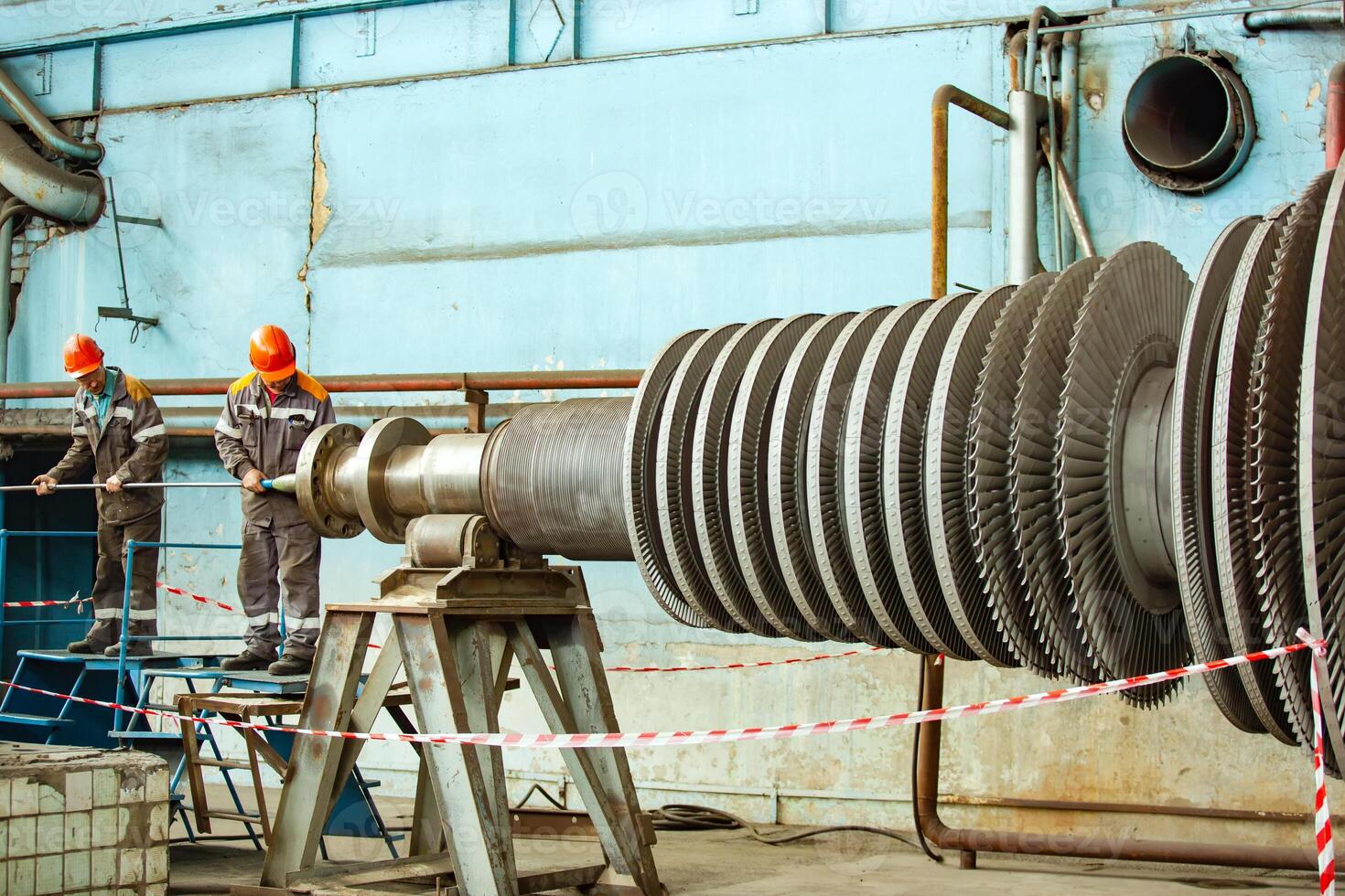 Steam turbine being worked on in an industrial manufacturing factory. photo