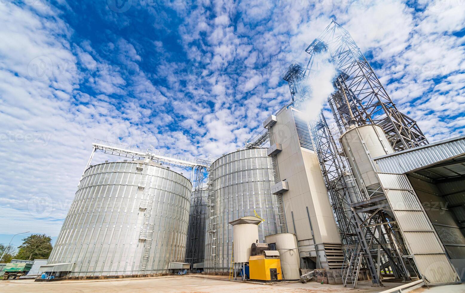 Tanks and agricultural silos of grain elevator storage. Loading facility building exterior. View from below. photo