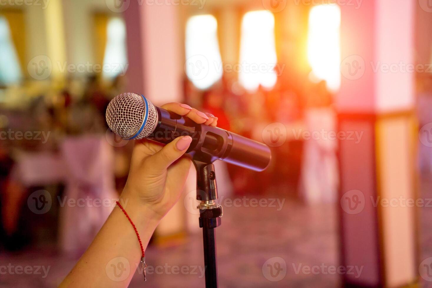 Microphone on stage. Microphone close-up. Microphone. A pub. Bar. A restaurant. Classical. Evening. Night show. Restaurant. photo