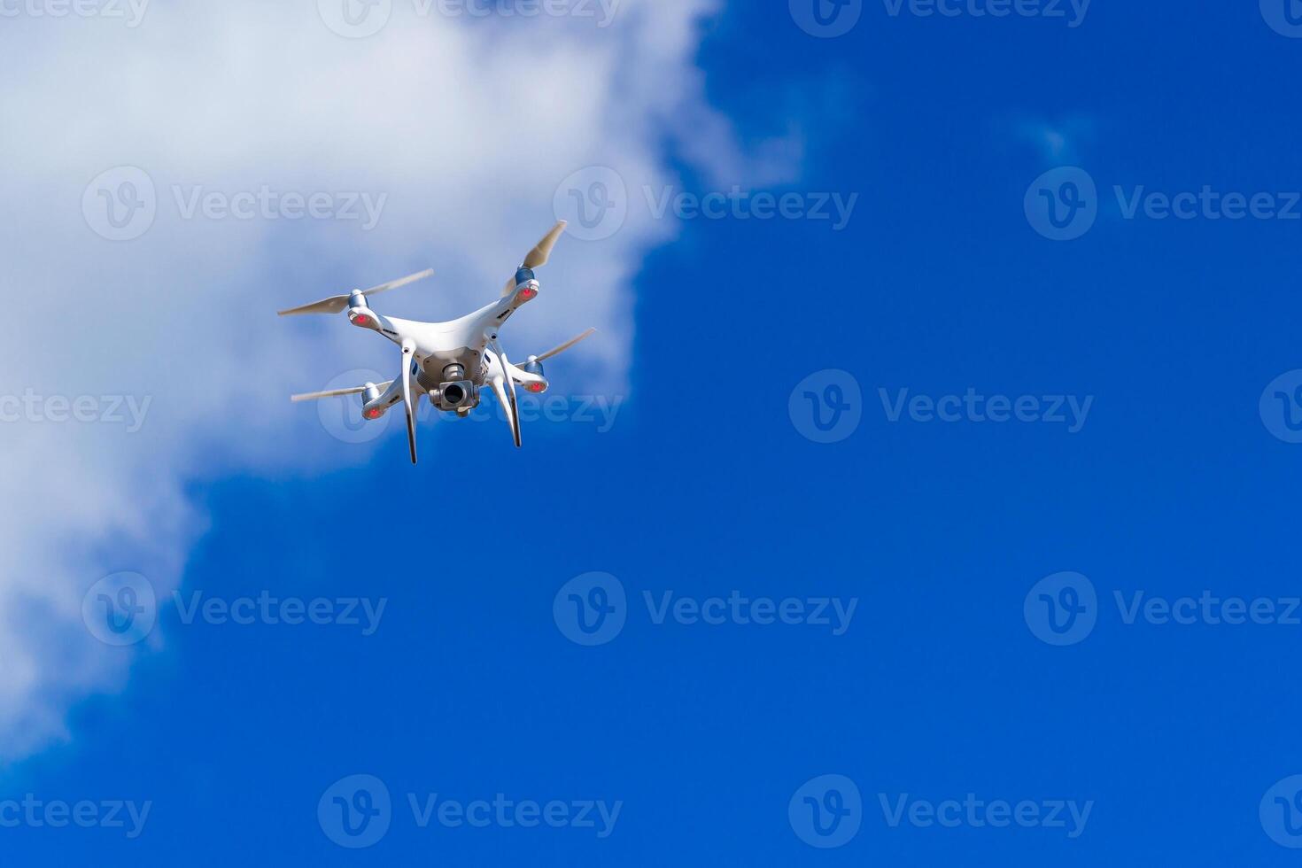 Quadrocopter flying in the sky. Modern dron in the air with camera. photo