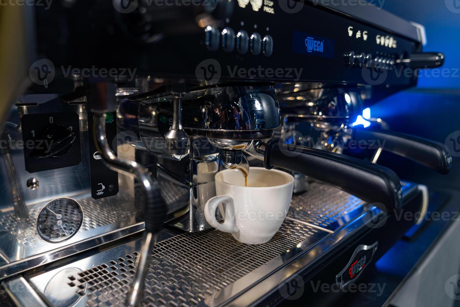 Making coffee with machine. Barista using coffee machine to make coffee in cafe. Stock photo