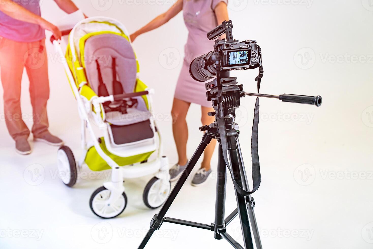 Making video in light studio for baby carriage. Camera standing in the photo studio.