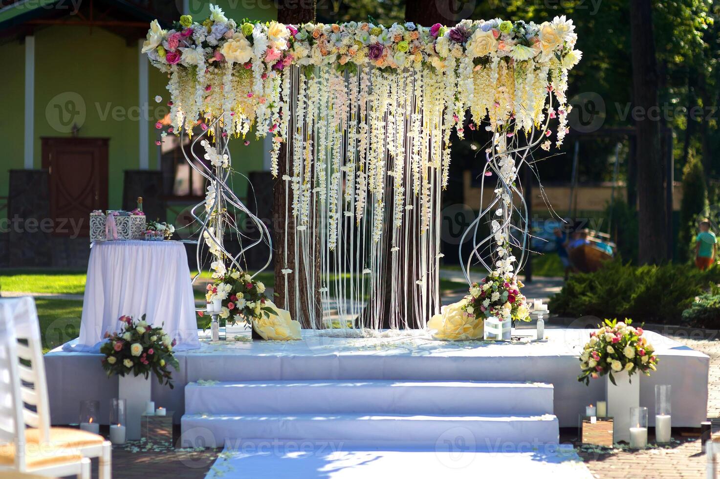 Arch for the wedding ceremony. Arch decorated with peachy and silvery cloth and flowers. photo