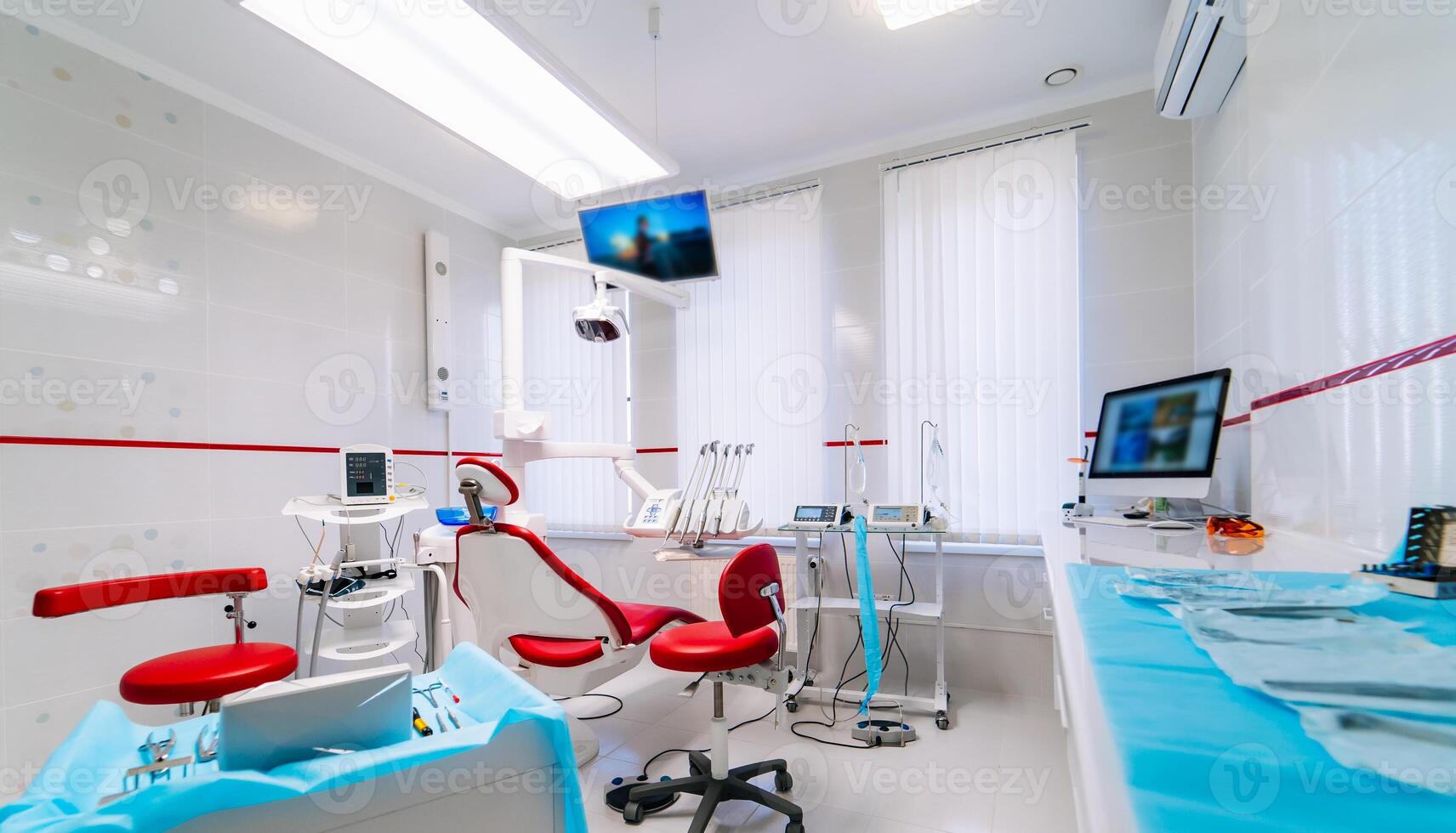 dentistry, medicine, medical equipment and stomatology concept - interior of new modern dental clinic office with chair photo