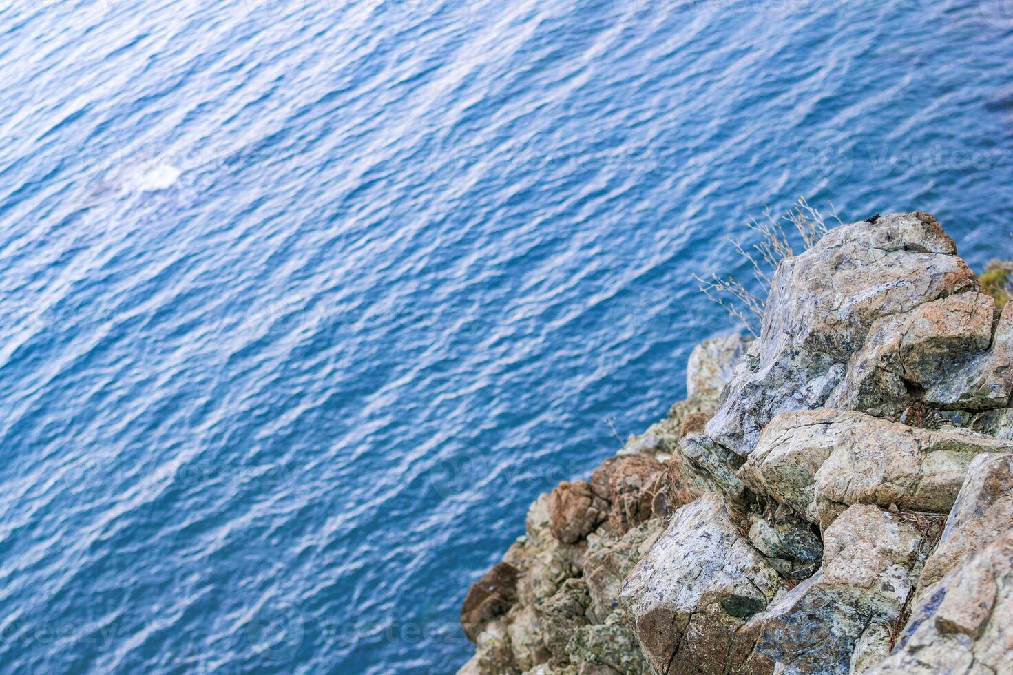 Tranquil scene with azure waters and unique rock formations. High cliff near to sea. photo