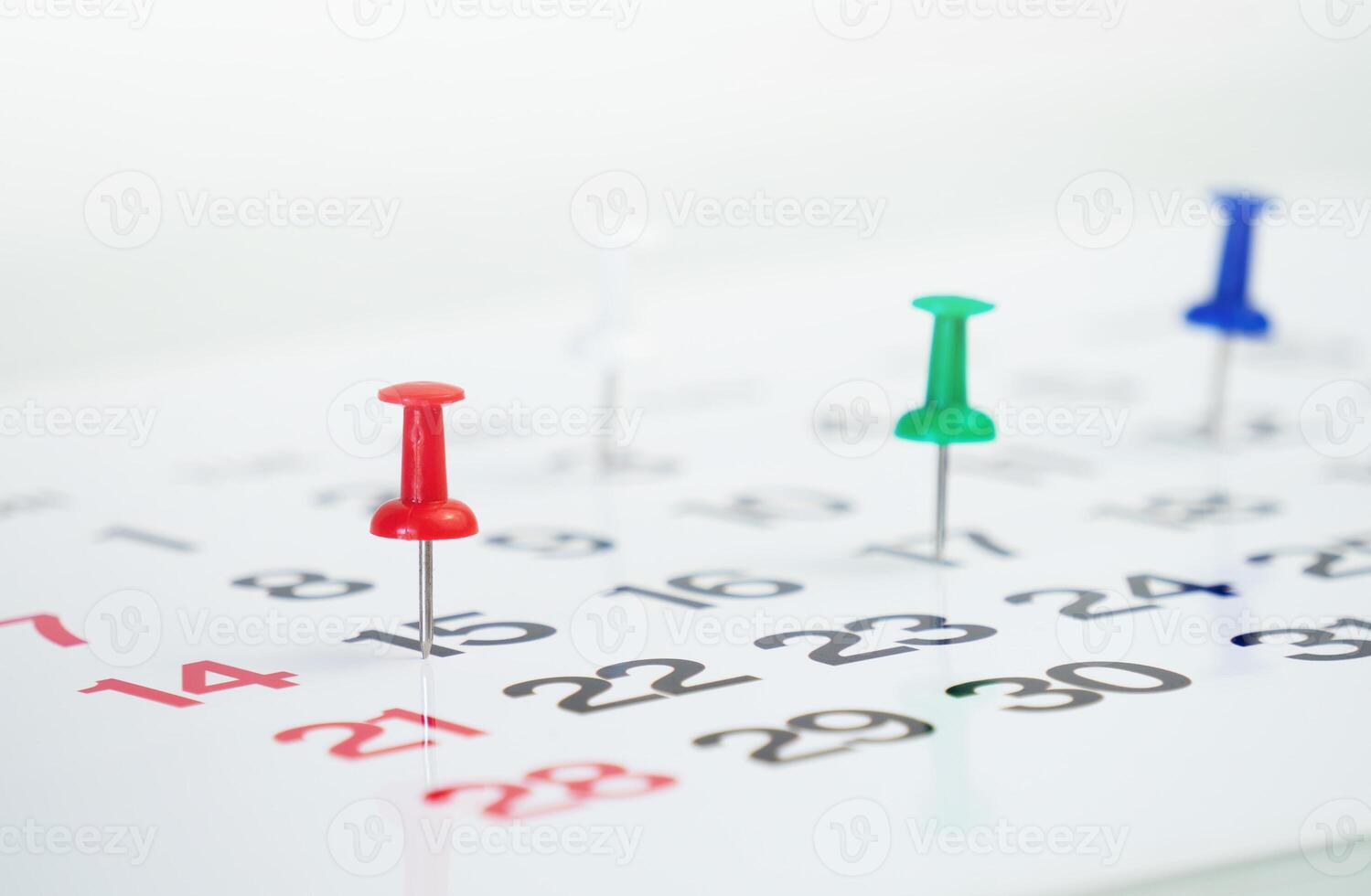 push pin on calendar background photo