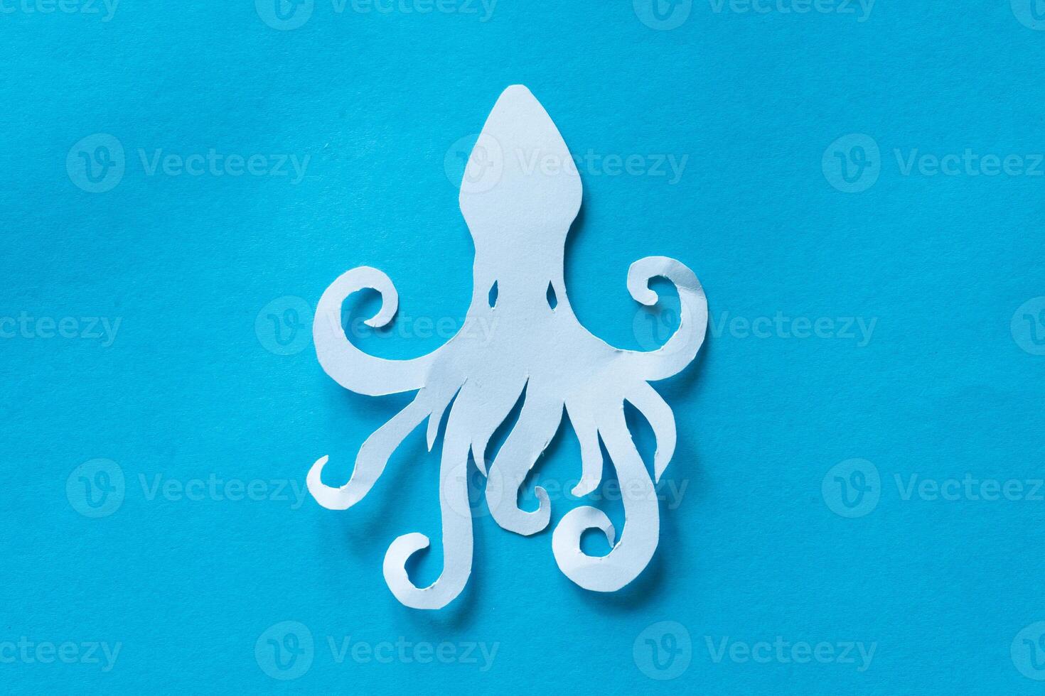 octopus paper cut out on blue background photo
