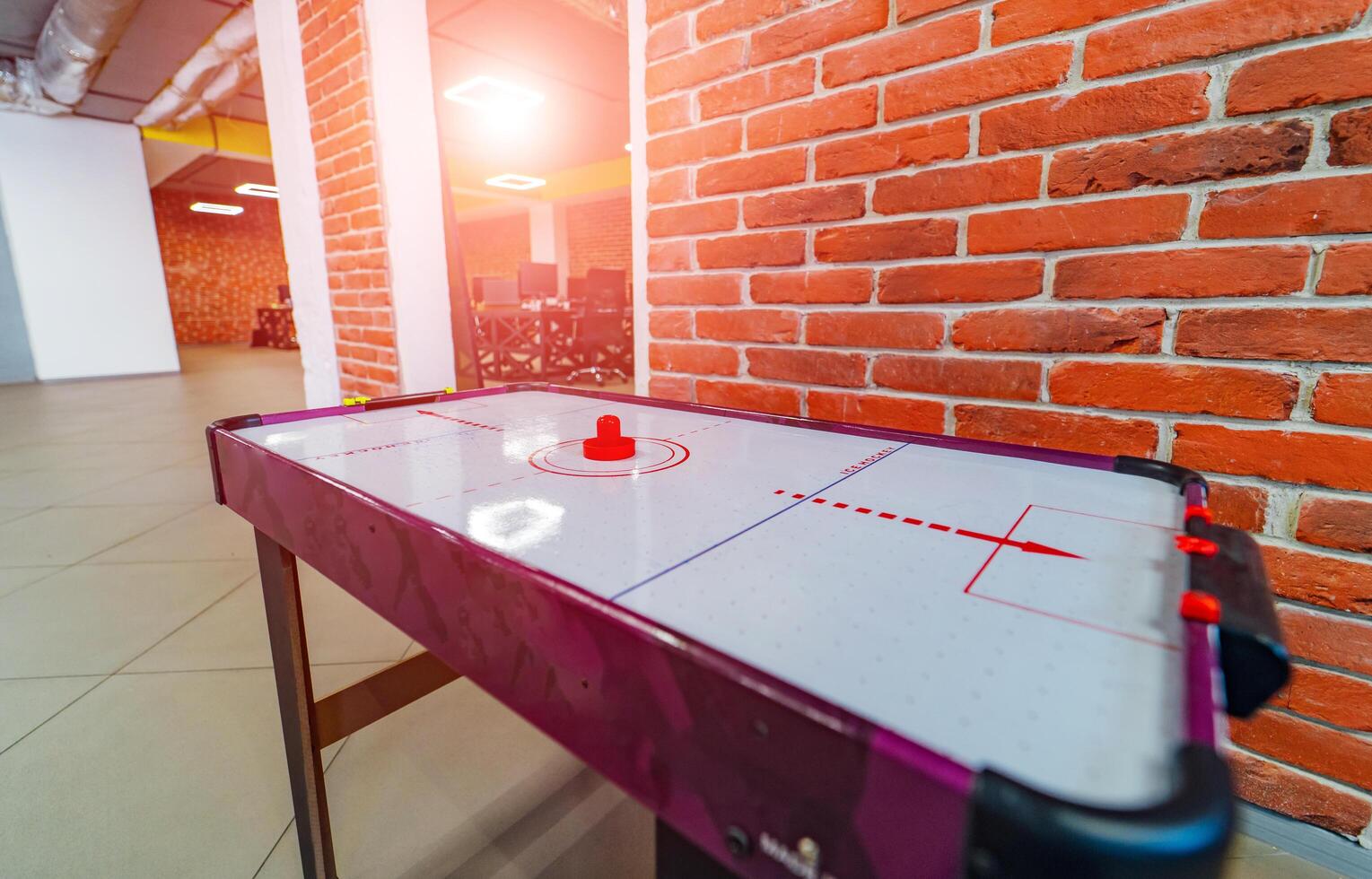 Air hockey table in office room. Leasure time at work. Modern office concept. Free to play. Comfortable working place. photo