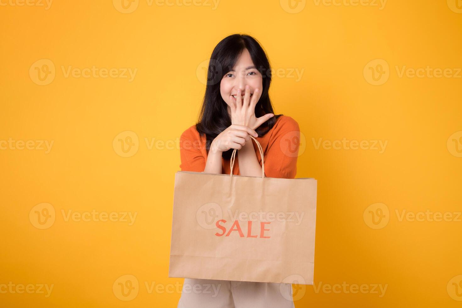 Join the celebration of incredible deals and shopping happiness. Trendy woman reveals her purchases, embodying the excitement of discovering the best bargains. photo