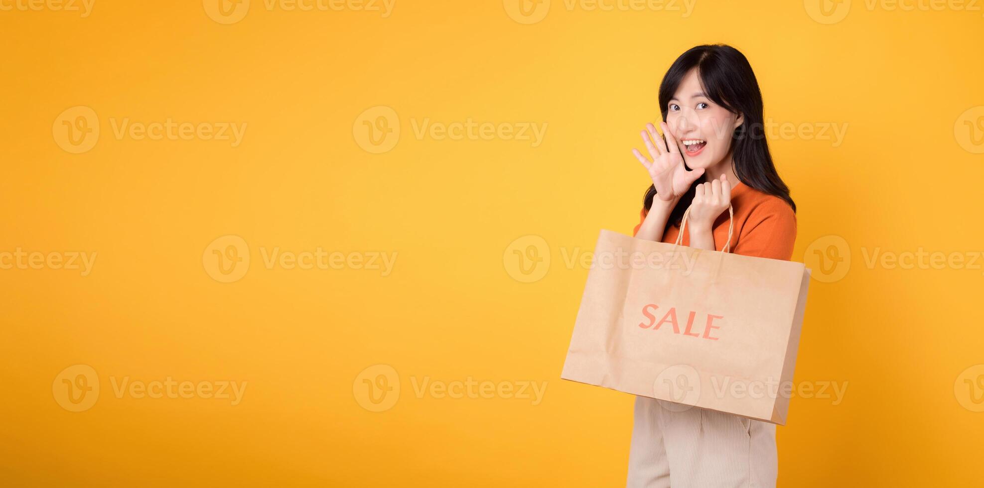 Experience the joy of shopping with a trendy twist. Young woman in her 30s celebrates fashion and discounts, showing her purchases in an exciting retail concept. photo