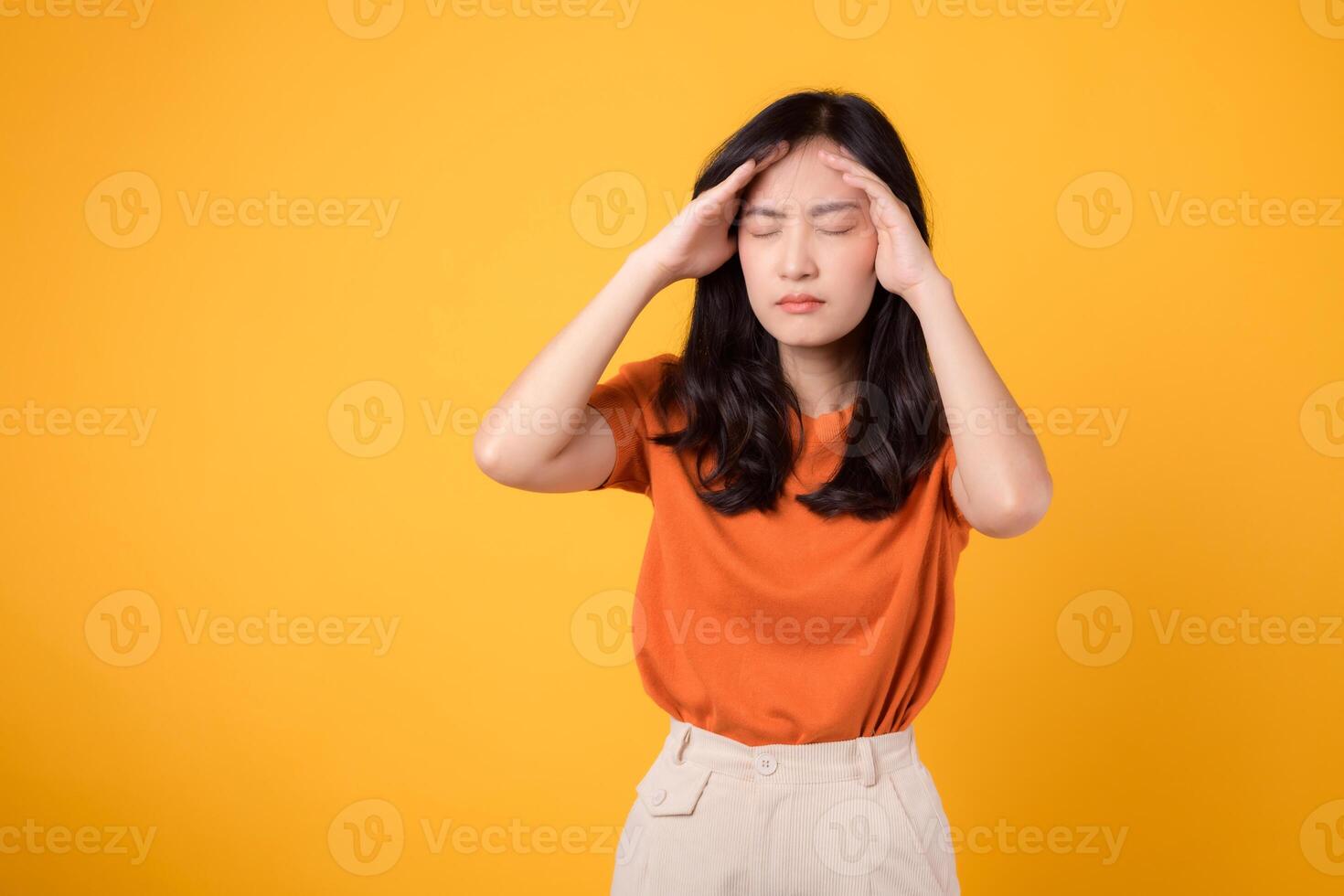 Stress takes its toll as a woman stands in the studio, her expression revealing pain, tension, and the weight of her emotions. photo