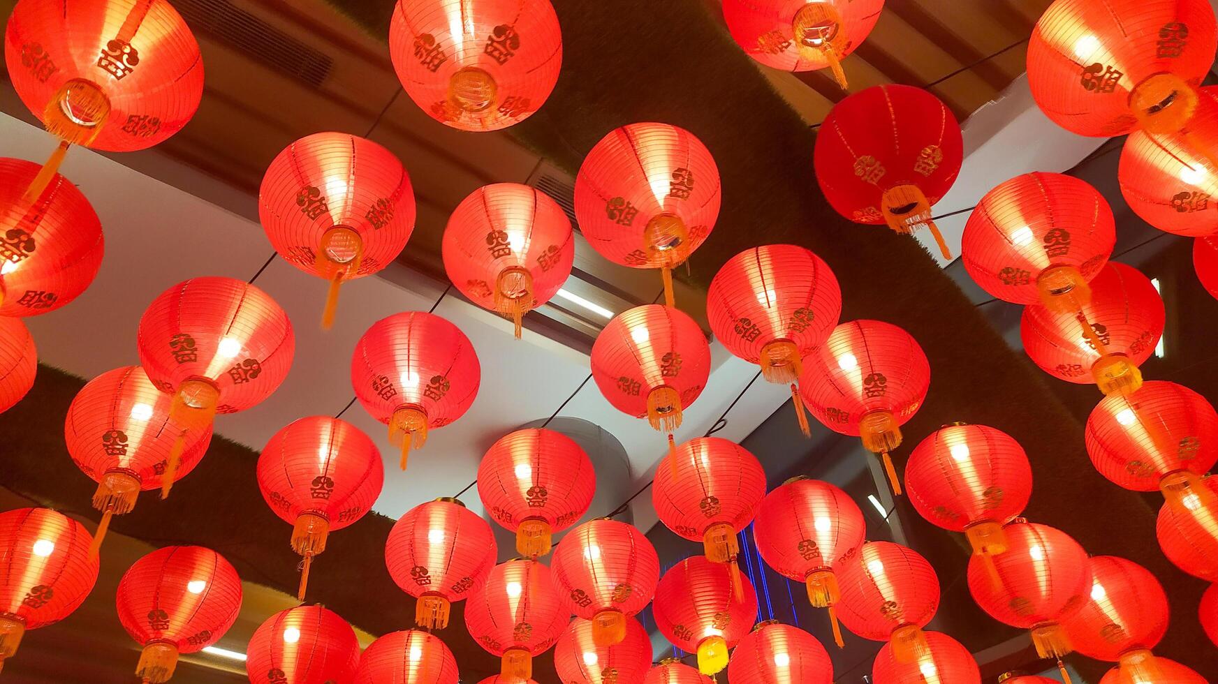 many red lanterns hanging from the ceiling photo