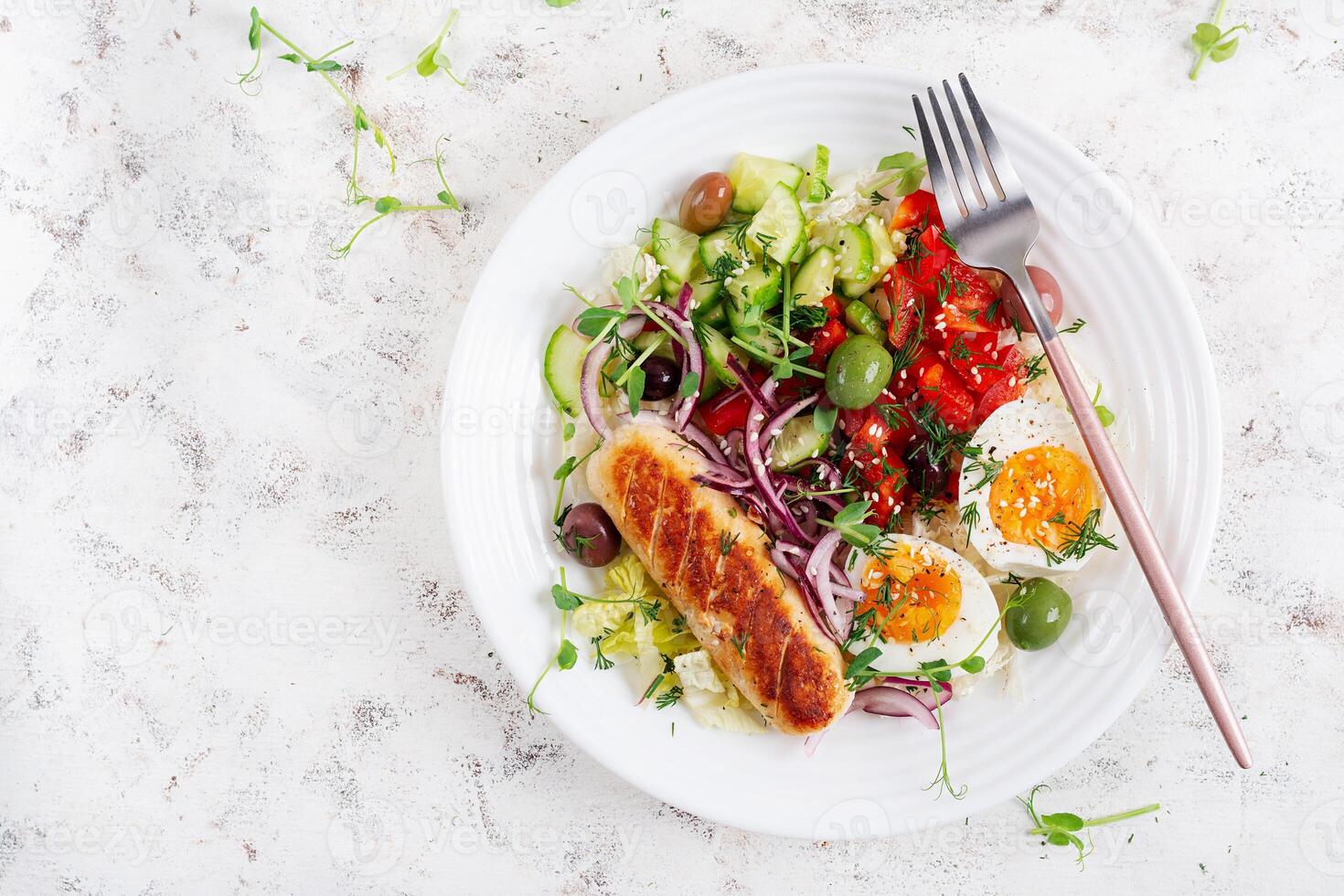 Breakfast homemade chicken sausage with boiled egg and fresh salad. Keto, ketogenic breakfast. Trendy breakfast. Top view, flat lay photo