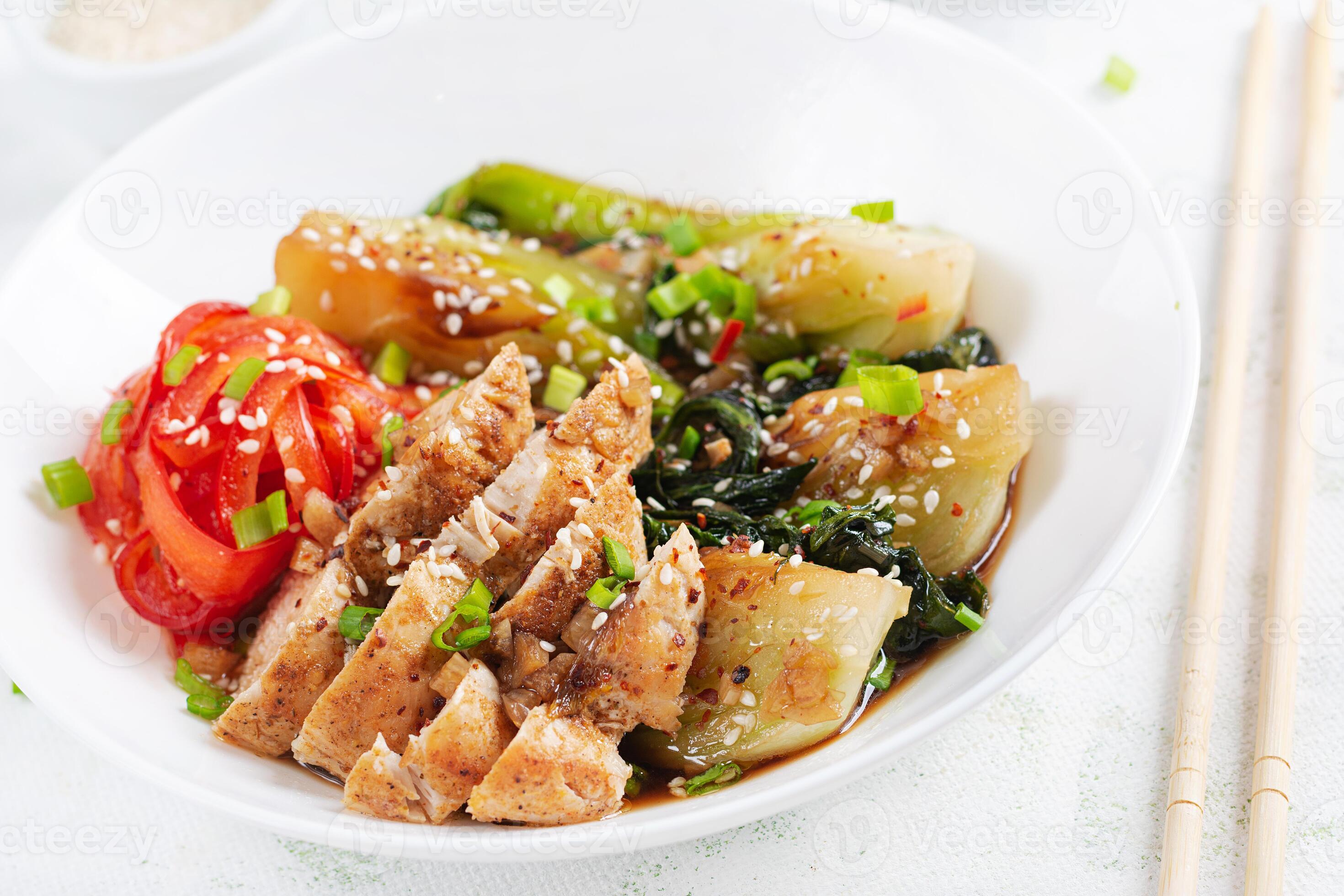Stir fried of chicken, sweet peppers and bok choy in a bowl on the