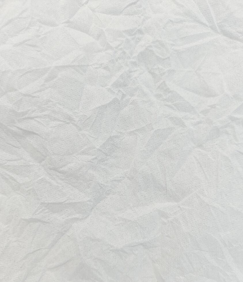Abstract creased or wrinkled or crumbled paper texture background, Old and stained paper with grainy and wrinkled or crumbled stains. photo