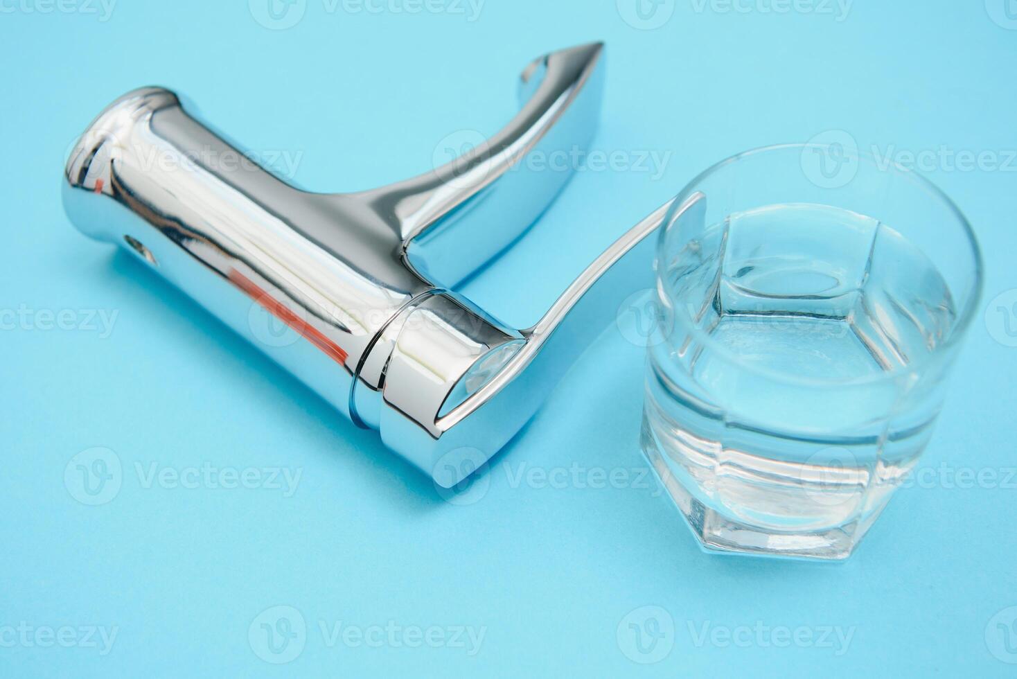 Single handle water tap on light blue background, closeup photo